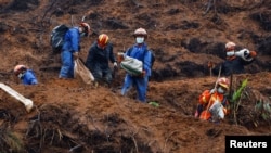 FILE - Rescue workers work at the site where a China Eastern Airlines Boeing 737-800 plane flying from Kunming to Guangzhou crashed, in Wuzhou, Guangxi Zhuang Autonomous Region, China, March 24, 2022. 