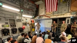 FILE - U.S. Marine Corps Gen. Frank McKenzie, the commander of U.S. Central Command, enters a plane evacuating people, at Hamid Karzai International Airport, Afghanistan, Aug. 17, 2021.