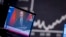 FILE - Russian President Vladimir Putin appears on a TV at the stock market in Frankfurt, Germany, Feb. 25, 2022, above the words, "Propaganda war online and on TV." Russia is accused of spreading disinformation aimed, in part, at influencing U.S. opinion to deny aid to Ukraine.