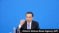 Chinese Premier Li Keqiang speaks during a press conference after the end of the closing session of China's National People's Congress (NPC) at the Great Hall of the People in Beijing, March 11, 2022.
