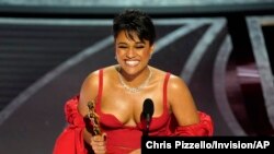 Ariana DeBose accepts the award for best performance by an actress in a supporting role for "West Side Story" at the Oscars, March 27, 2022.