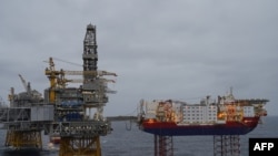 FILE - Platforms producing oil stand in the North Sea over the Johan Sverdrup oil field, some 140 kilometers west from the town of Stavanger, Norway, Dec. 3, 2019.