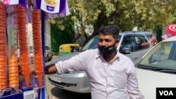 Ice cart owner, Mustaq Ahmed says as people shed their hesitation on eating outside, his earnings are improving.