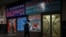 FILE - A man walks past a store advertising cargo shipping to Russia and other countries, along a street in Beijing, March 4, 2022. 