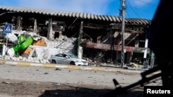 FILE - Destroyed houses are pictured at the border between Bucha and Irpin, amid Russia's invasion of Ukraine, in Irpin, March 11, 2022.