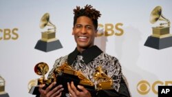 Jon Batiste, winner of the awards for best American roots performance for "Cry," best American roots song for "Cry," best music video for "Freedom," best score soundtrack for visual media for "Soul," and album of the year for "We Are," poses in the press room at the 64th Annual Grammy Awards at the MGM Grand Garden Arena on Sunday, April 3, 2022, in Las Vegas.