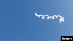 A trail of smoke is seen after Blue Origin's rocket New Shepard blasted off, on billionaire Jeff Bezos's company's fourth suborbital tourism flight with a six-person crew, near Van Horn, Texas, U.S., March 31, 2022.