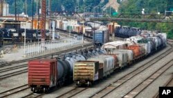 FILE - Freight cars wait to be hauled out of the Norfolk Southern Conway Terminal in Conway, Pennsylvania, Sept. 15, 2022. 