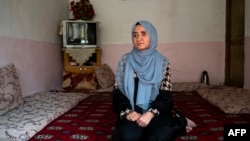 Afghan Hazara student Fatima Amiri sits during an interview with AFP at her home in Dasht-e-Barchi, in Kabul, Afghanistan, Nov. 7, 2022.