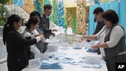 Election commission members count ballots at a polling station in Almaty, Kazakhstan, Nov. 20, 2022. 