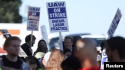 FILE - Academic workers at the University of California-San Diego walk out as thousands of employees at the UC campuses strike to secure improved pay and working conditions, in San Diego, Nov. 14, 2022.