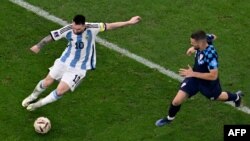 Argentina's Lionel Messi, left, vies with Croatia's Mateo Kovacic during their World Cup semifinal match in Lusail, Qatar, Dec. 13, 2022.
