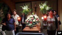 FILE - Relatives, friends and journalists stand vigil beside the coffin of slain journalist Regina Martinez during her wake in Xalapa, Mexico, April 30, 2012.