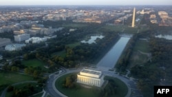 The skyline of Washington, DC, including the Lincoln Memorial, Washington Monument, US Capitol and National Mall, is seen from the air at sunset in this photograph taken on June 15, 2014. 