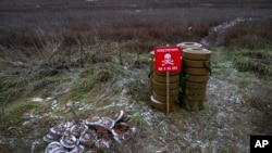 FILE - Anti-tank mines are seen in the field near the recently liberated village of Pravdyne, Kherson region, Ukraine, Dec. 6, 2022. 