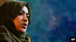 Batool Haidari, 37, talks during an interview with The Associated Press on a train taking her from her home on the outskirts of Rome, to the capital's center, Dec. 5, 2022. 