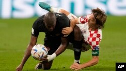 Croatia's Luka Modric fights for the ball with Canada's Kamal Miller during the World Cup group F soccer match between Croatia and Canada, at the Khalifa International Stadium in Doha, Qatar, Nov. 27, 2022.
