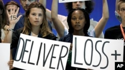 Activists encourage world leaders to maintain policies that limit warming to 1.5 degrees Celsius and provide reparations for loss and damage at the COP27 UN Climate Summit, Nov. 19, 2022, in Sharm el-Sheikh, Egypt.