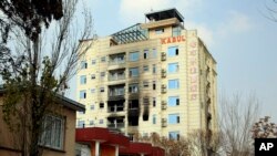 A hotel building sits charred after an attack in Kabul, Afghanistan, Dec. 13, 2022. The militant Islamic State group has claimed responsibility for a coordinated attack on the Chinese-owned hotel in the capital.