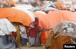 FILE - A Somali woman stands in the Alla Futo camp for internally displaced people, on the outskirts of Mogadishu, Somalia, Sept. 23, 2022.