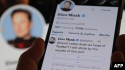 FILE - This photo illustration made on Dec. 18, 2022 in Los Angeles shows a phone displaying Elon Musk's Twitter page where he is conducting a survey about his future as the head of the company.