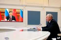 Russian President Vladimir Putin speaks with Chinese President Xi Jinping via a video conference at the Kremlin in Moscow, Russia, Dec. 30, 2022.