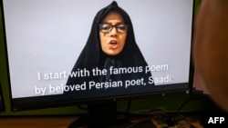A person on Nov. 28, 2022 watches Farideh Moradkhani, the niece of Supreme Leader Ali Khamenei, speaking in a video posted on YouTube. 