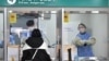 A health worker takes a nasal swab from a traveler arriving from China at a COVID-19 testing center at Incheon International Airport, west of Seoul on Jan. 3, 2023. 