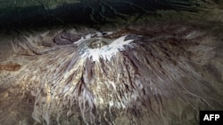 FILE - This satellite image taken from Nasa's Earth Observatory shows Tanzania's Mount Kilimanjaro on Feb. 21, 2000. 