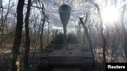 A German howitzer Panzerhaubitze 2000 is disguised by the Ukrainian army of the 43rd Heavy Artillery Brigade, as Russia's attack on Ukraine continues, near Soledar, Ukraine, Jan. 11, 2023.