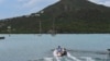 FILE - Tourists sit on a boat in English Harbour, Antigua and Barbuda, on Sept. 18, 2022. 