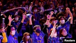 FILE- Japanese soccer fans react after Japan won a FIFA World Cup Qatar 2022 match with Germany, at a public viewing event in Tokyo, Japan, Nov. 23, 2022. 