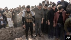 FILE - Syrian Kurds attend a funeral of people killed in Turkish airstrikes in the village of Al Malikiyah, northern Syria, Nov. 21, 2022. Turkey said the airstrikes were aimed at Kurdish militants whom Ankara blamed for a deadly bombing in Istanbul.