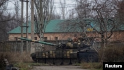 Ukrainian servicemen ride a tank in Bakhmut, Ukraine, Dec. 18, 2022. 