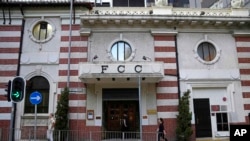 FILE - People walk past the Hong Kong Foreign Correspondents' Club in Hong Kong, Nov. 5, 2021. 