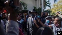 FILE - Haiti Senate President Joseph Lambert, center, arrives for a press conference at the Senate chambers, in Port-au-Prince, Jan. 10, 2022.