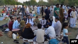 Afghan refugees seeking asylum abroad gather at an open field in protest to demand help from the U.N. High Commissioner for Refugees in Islamabad on May 7, 2022. 