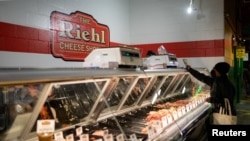 FILE - A customer shops at a deli in Reading Terminal Market after the inflation rate hit a 40-year high in January, in Philadelphia, Pennsylvania, Feb. 19, 2022. 