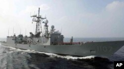 FILE - A Perry-class frigate from the Taiwanese navy runs through exercises off Kaohsiung, Taiwan.