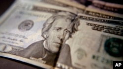 FILE - U.S. household income fell for the first time in two years, mostly due to declines in the stock market. This June 13, 2018, photo shows U.S. currency. 