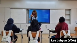 FILE - Three Afghan students participate in a Korean language class at Myeongdeok Girl's Middle School in Ulsan, South Korea, April 27, 2022.
