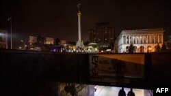 Pedestrians walk an underground pass during a power cut at Independence Square in downtown Kyiv on Nov. 10, 2022, amid the Russian invasion of Ukraine.