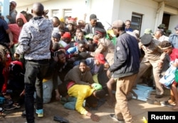 People fall into a stampede as they jostle to attend the inauguration of Kenya's President William Ruto, before his swearing-in ceremony at the Moi International Stadium Kasarani in Nairobi, Sept. 13, 2022.