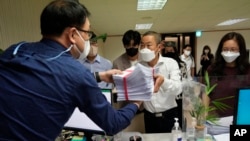 Peter Møller, center, attorney and co-founder of the Danish Korean Rights Group, submits the documents at the Truth and Reconciliation Commission in Seoul, South Korea, Tuesday, Sept. 13, 2022. 