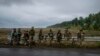 Ukrainian servicemen rest at a former Russian position in the recently retaken area of Izium, Ukraine, Sept. 16, 2022. 