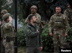 ولودیمیر زلنسکی، رئیس جمهوری اوکراین، به هنگام بازدید از شهر آزاد شده ایزیوم در منطقه خارکیف در شمال شرق اوکراین. ۱۴ سپتامبر ٢٠٢٢