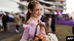 FILE - A model presents a creation by local designers during a fashion show in Durban, South Africa, July 2, 2022.