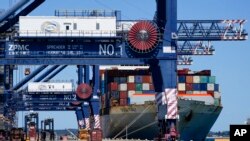 FILE - A container ship is unloaded at Port Botany in Sydney, Australia, Oct. 5, 2021. 