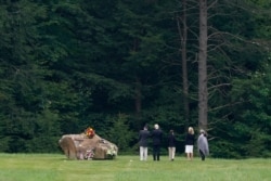 Democratic presidential candidate Joe Biden and his wife, Jill Biden, visit with a family at a boulder marking the impact site of Flight 93 at the Flight 93 National Memorial in Shanksville, Pa., Sept. 11, 2020.