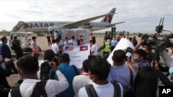 FILE - Journalists surround donated COVID-19 vaccines at the Phnom Penh International Airport in Phnom Penh, Cambodia, July 30, 2021. A report by a U.N. human rights agency finds increasing restrictions being placed on journalists, some related to COVID-19 measures.